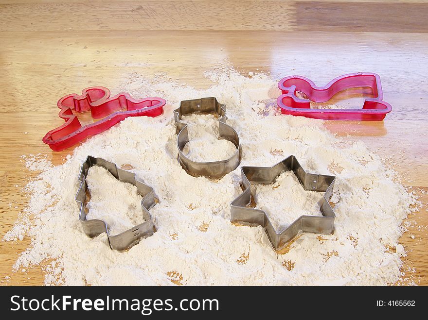 Holiday shaped cookie cutters in flour. Holiday shaped cookie cutters in flour