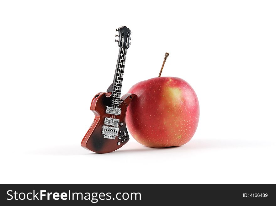 Close-up of a guitar and apple