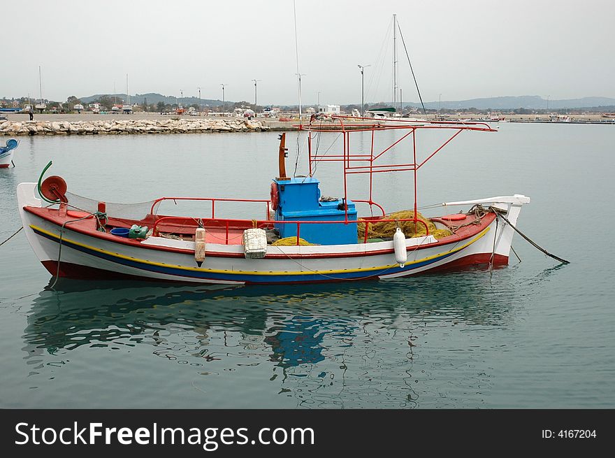 Colorful fishing boat anchored in ocean in greece. Colorful fishing boat anchored in ocean in greece