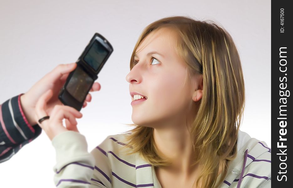 Female young adult answering to the phone. Female young adult answering to the phone