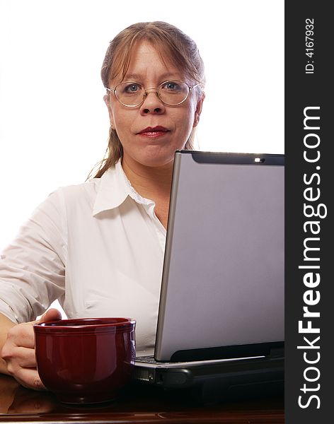 Attractive woman wearing eyeglasses working on convertible notebook laptop computer. Attractive woman wearing eyeglasses working on convertible notebook laptop computer