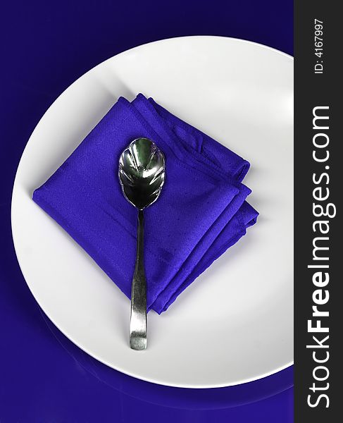 A modern restaurant place setting in blue. A modern restaurant place setting in blue