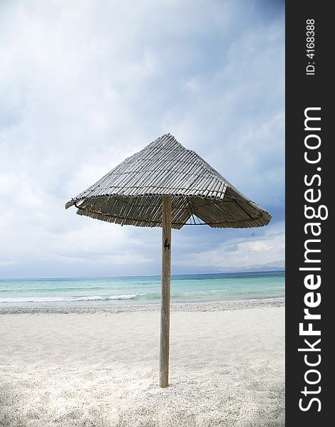 Lonely parasol at christi island near crete