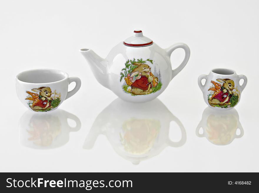 Rabbit tea or coffee set on a reflective white background. Rabbit tea or coffee set on a reflective white background
