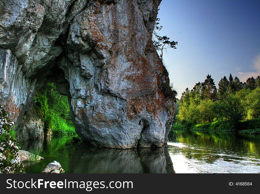 Rock similar to the horse drinking water, The Ural mountains, in Russia, park Olen'i the river