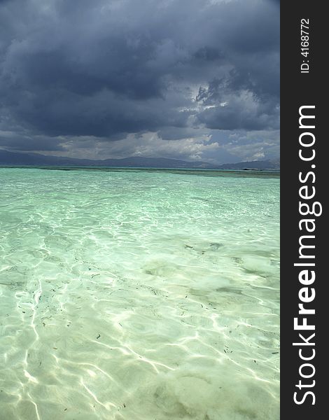 Crete coast view since a crystalline beach and wiht stormy clouds. Crete coast view since a crystalline beach and wiht stormy clouds