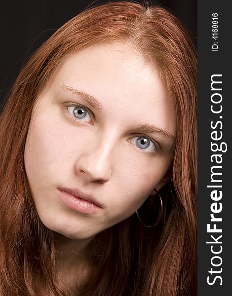 Beautiful redhead with blue eyes, closeup portrait