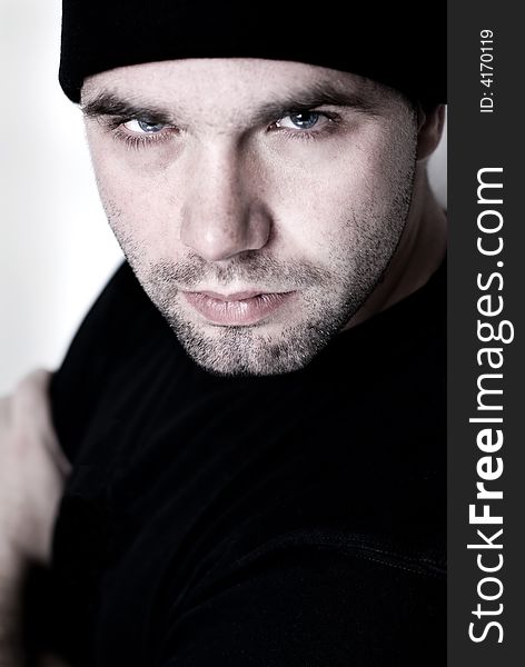 Portrait of young man wearing beanie - selective focus on the model's right eye. Portrait of young man wearing beanie - selective focus on the model's right eye.