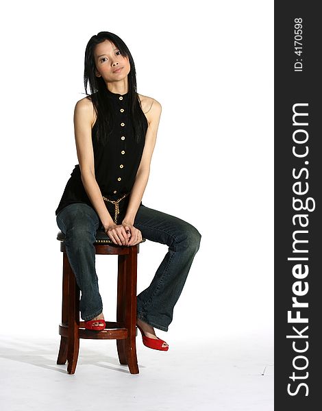 Attractive Asian Woman Sitting On A Stool