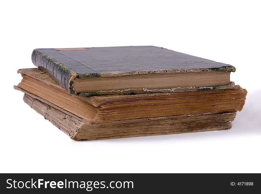 Pile from three ancient books. Isolated on white background.