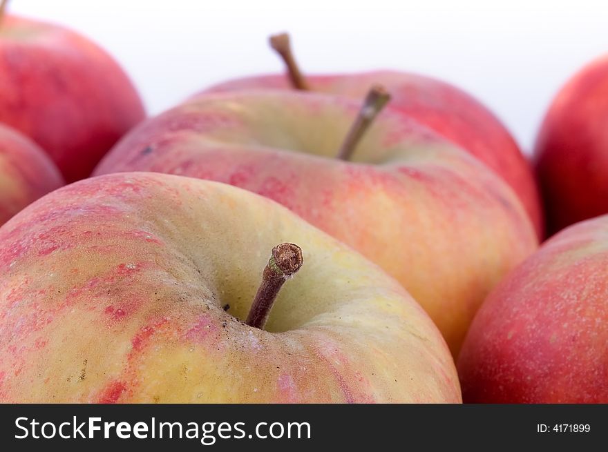 Close-up on fresh red apples on white background.