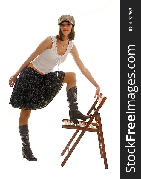 Young woman near the chair dresses in skirt. Young woman near the chair dresses in skirt