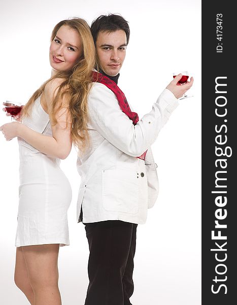 The man and the woman in white clothes with red wine. The man and the woman in white clothes with red wine