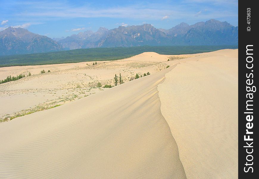 Chara desert. sand dunes and far mountains. Chara desert. sand dunes and far mountains