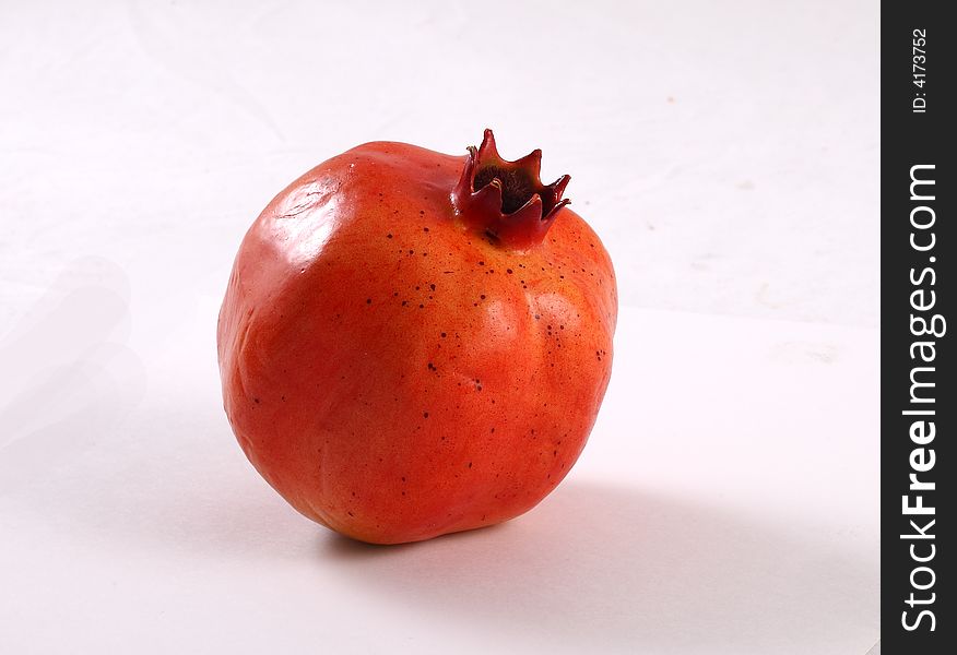 Whole pomegranate isolated on white background