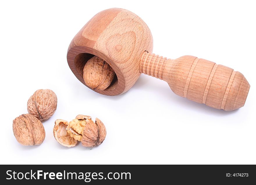 Closed and broken walnuts with nutcracker