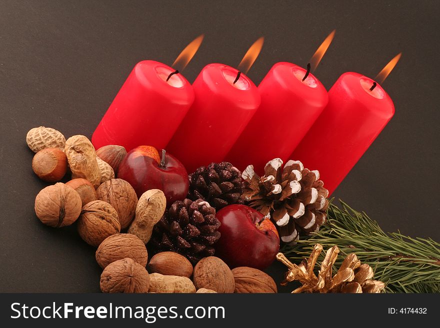 Advent red candels and still life on a black background.