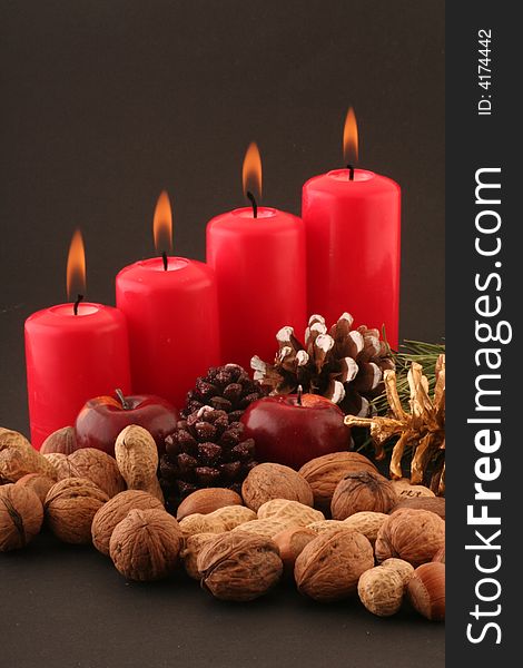 Advent red candels and still life on a black background.