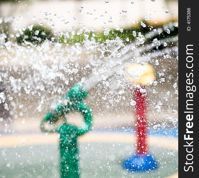 Water droplets colliding in mid air in a children's water playground. Water droplets colliding in mid air in a children's water playground