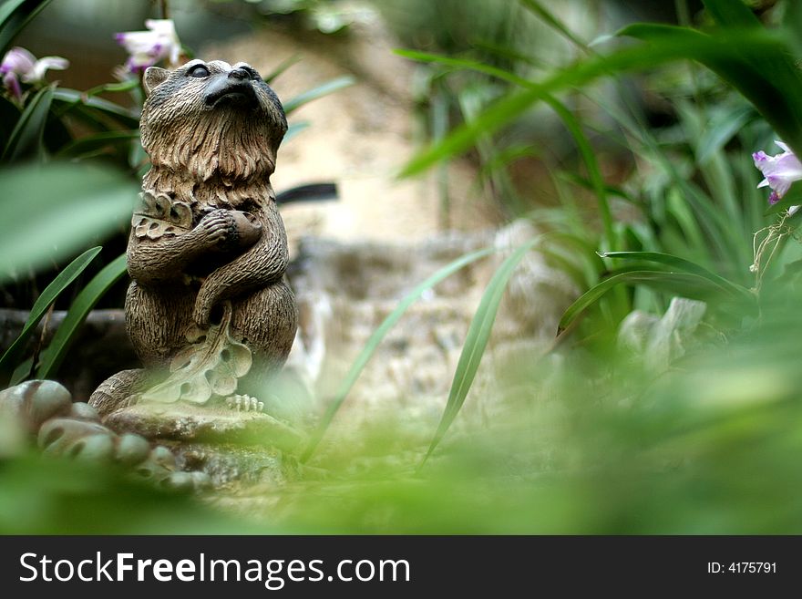 A shot at a garden with a sulpture of the fox guardian.