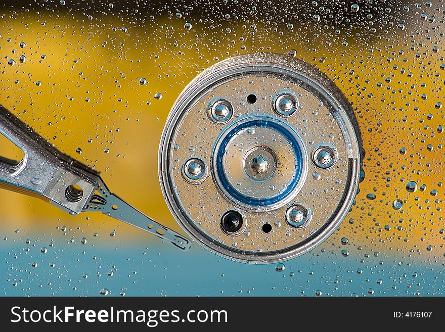 Macro shot of an hard disk with drops of water. Macro shot of an hard disk with drops of water