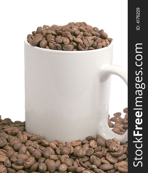 Cup full of coffeebeans isolated on white. Cup full of coffeebeans isolated on white