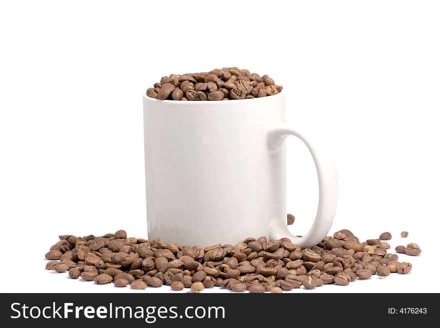 Coffee eans in a cup isolated on white