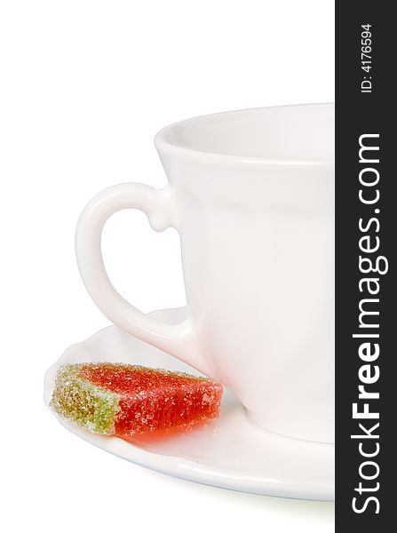 White tea cup and slices of fruit candy