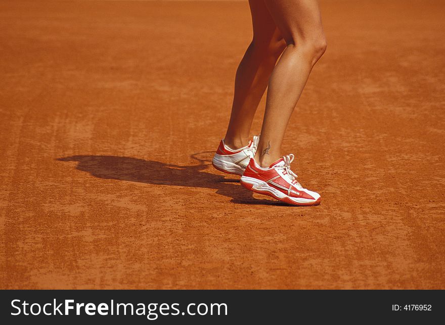 Feet on tennis court in paris