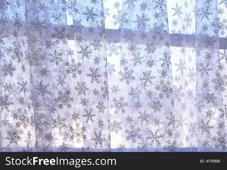 Snowflake gauze curtain hanging at a window. Snowflake gauze curtain hanging at a window