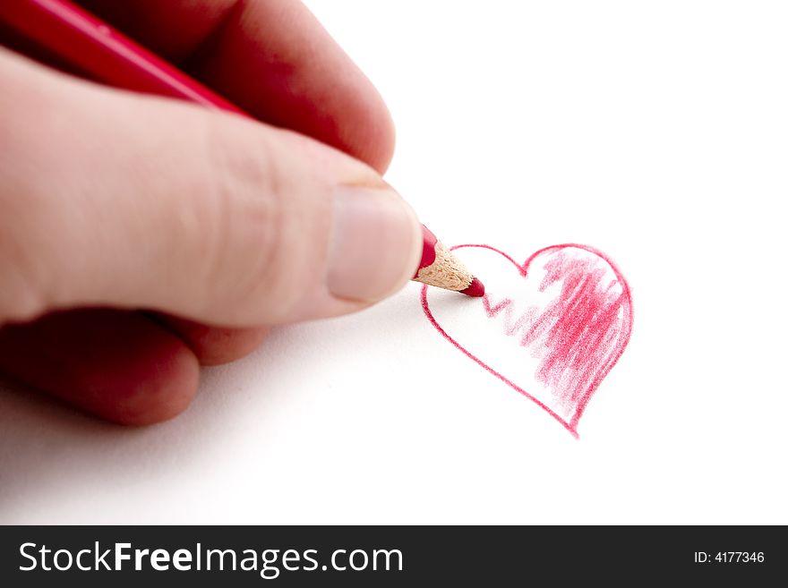 White hand coloring red heart with wooden pencil. White hand coloring red heart with wooden pencil