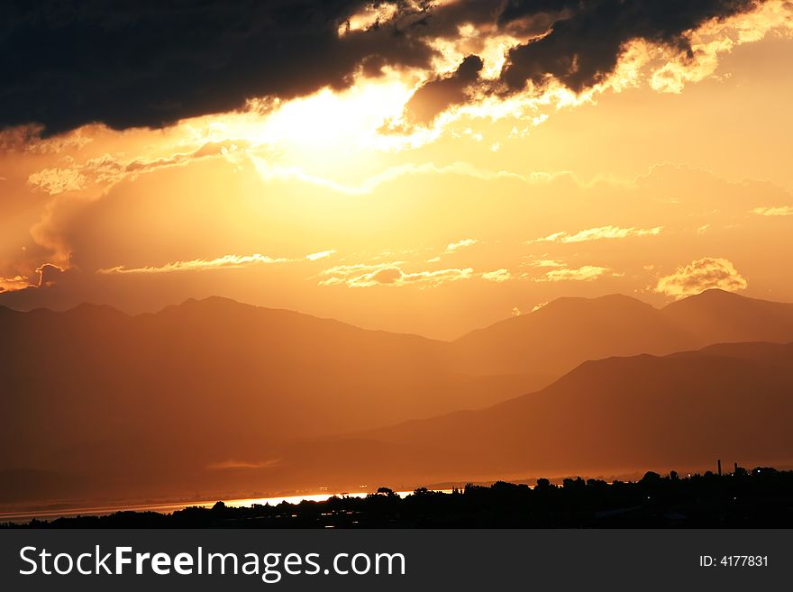 Sun setting over valley casts a copper cast. Sun setting over valley casts a copper cast