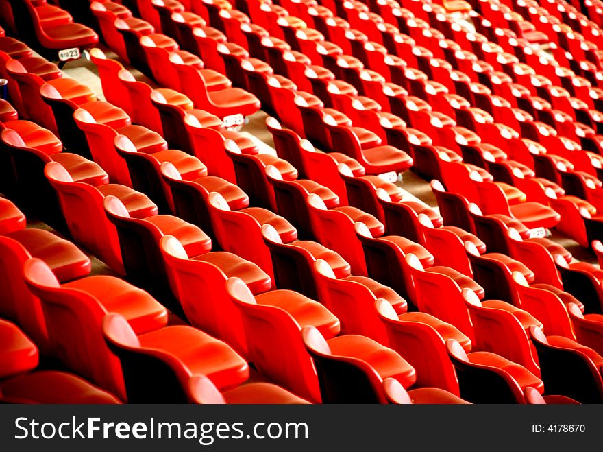 Curves of red chairs in a stadium ,lines,waves,oblique lines