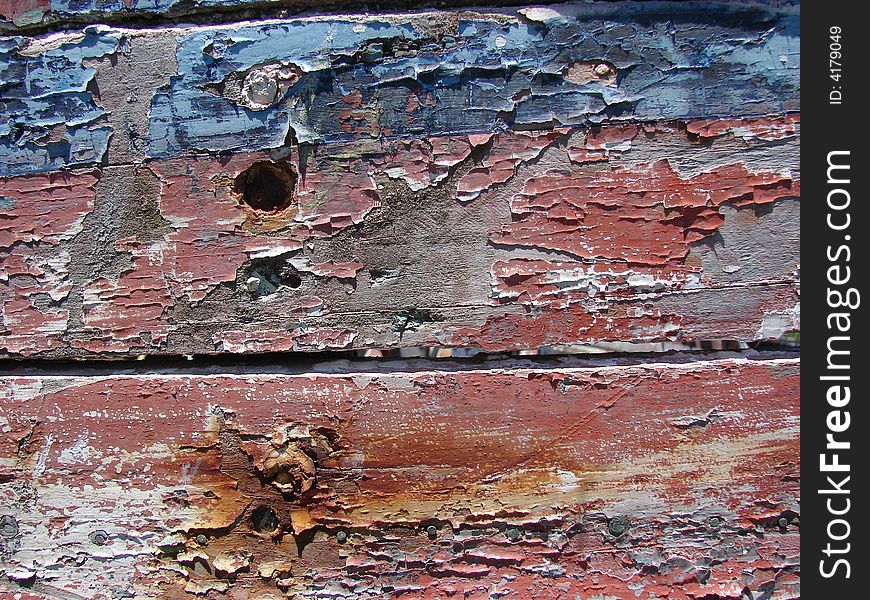 Red, and blue peeling paint on old boards. Red, and blue peeling paint on old boards
