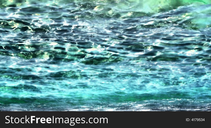 Crystal clear turquoise beach water rippling in sunlight. Crystal clear turquoise beach water rippling in sunlight