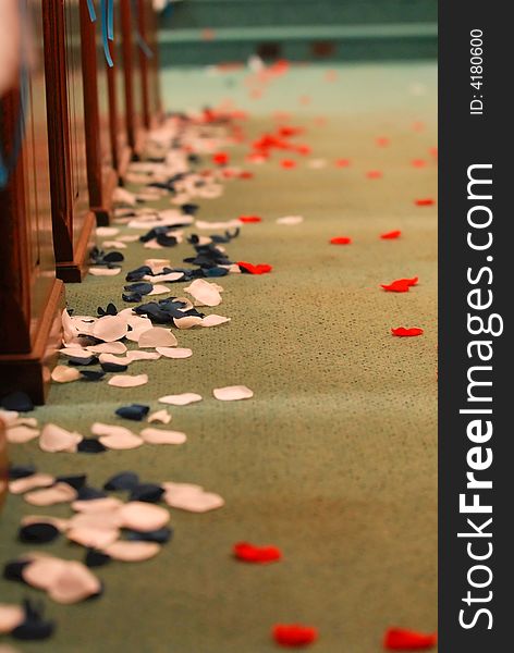 Rose pedals in an aisle of a church for a wedding. Rose pedals in an aisle of a church for a wedding.