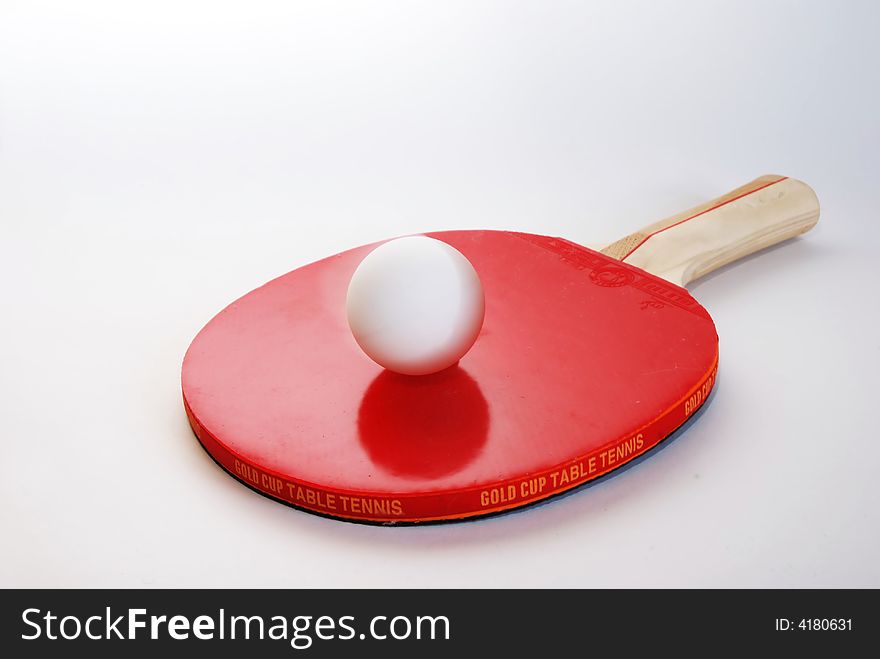 Red ping-pong paddle with the ball isolated on white