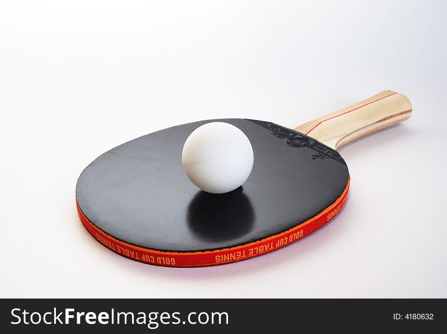 Black ping-pong paddle with the ball isolated on white