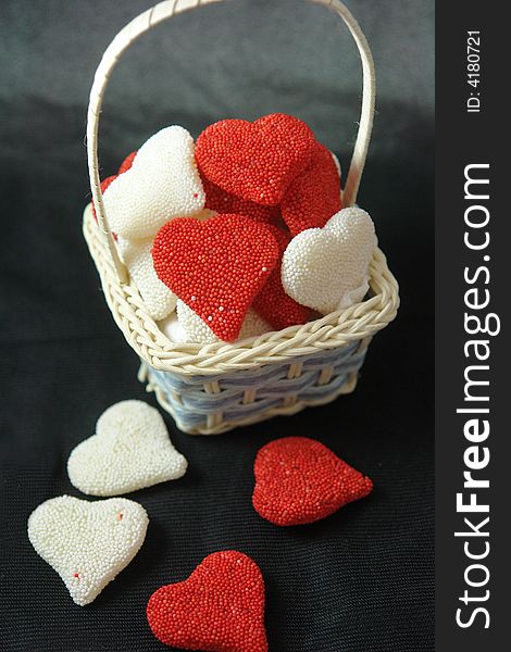 A picture of a basket of valentine red and white hearts. A picture of a basket of valentine red and white hearts