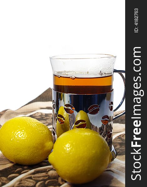 Black tea whith lemon in the transparent mug. Black tea whith lemon in the transparent mug