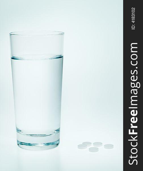 Aspirin and water in a blue tone