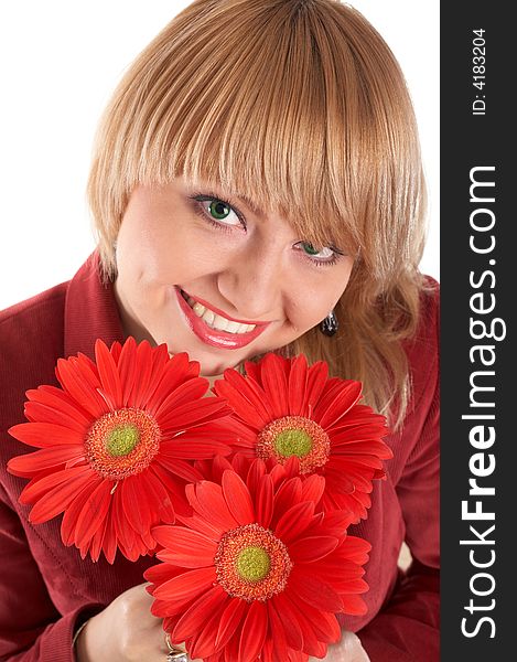 A smiling green-eyed girl with red flowers