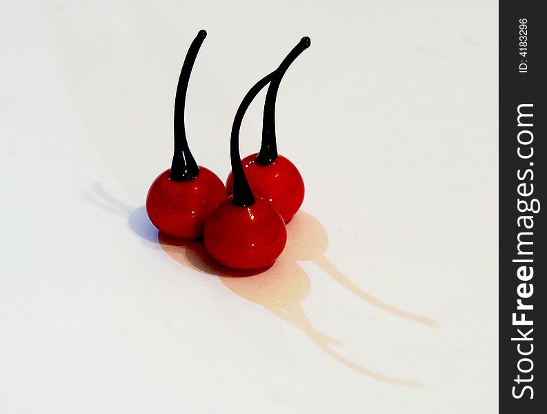 Three cherrys made from glass  with shadow