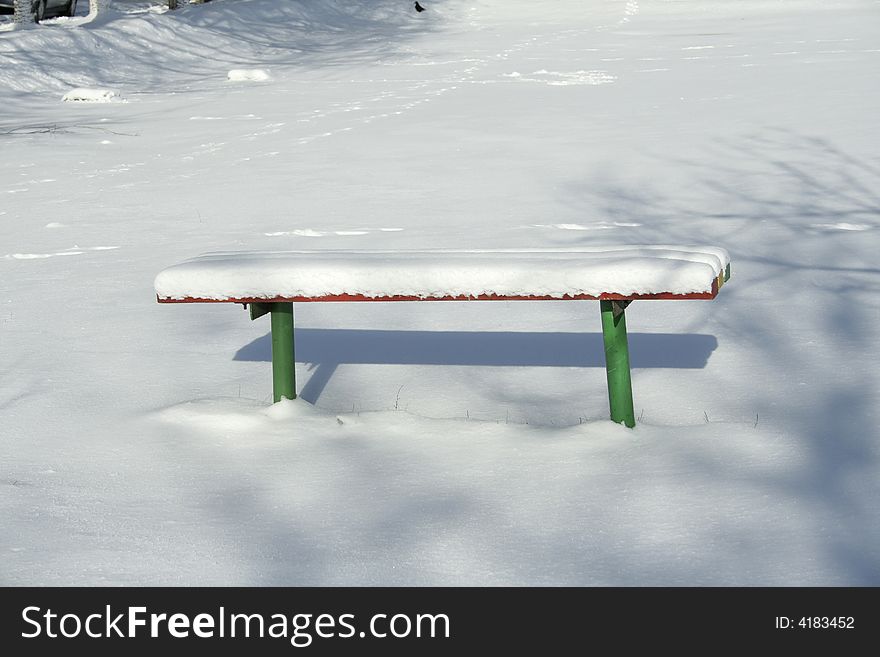 Wood bench in snow