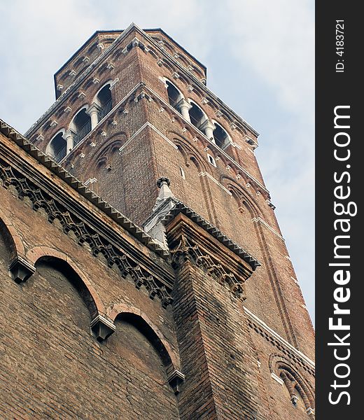 Church tower in Venice, Italy, against sky; looking up view