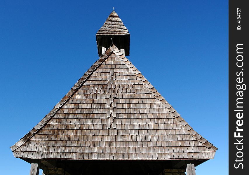 Wooden roof of a chapel in mountains on a background of the dark blue sky. Southern Bavaria. Wooden roof of a chapel in mountains on a background of the dark blue sky. Southern Bavaria.