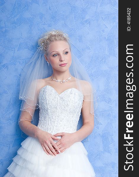 Pensive bride on the blue background