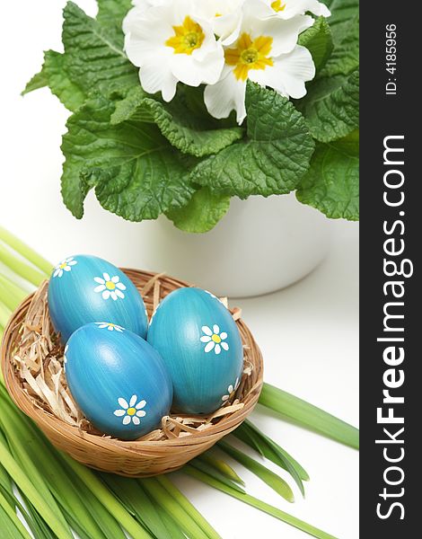 Blue easter eggs in basket on grass with flower. Blue easter eggs in basket on grass with flower.