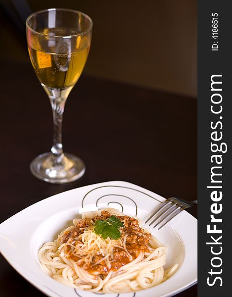 Spaghetti and wine on dark table. Spaghetti and wine on dark table