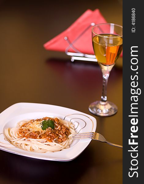 Spaghetti and wine on dark table. Spaghetti and wine on dark table